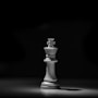 white chess piece on black table