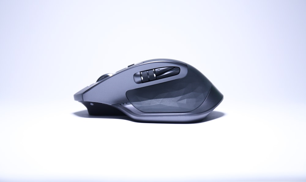 black cordless computer mouse on white surface