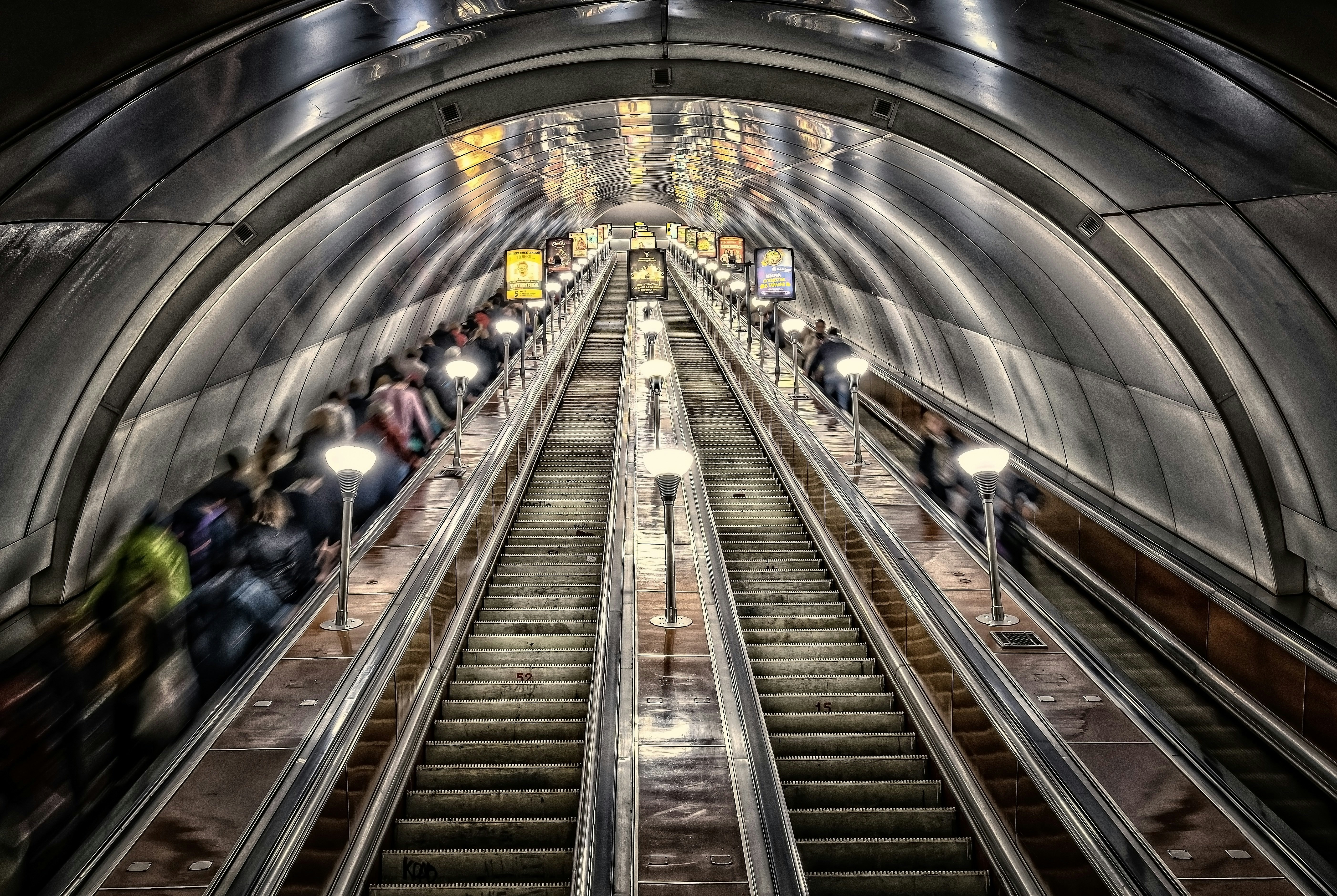 people walking on escalator inside building