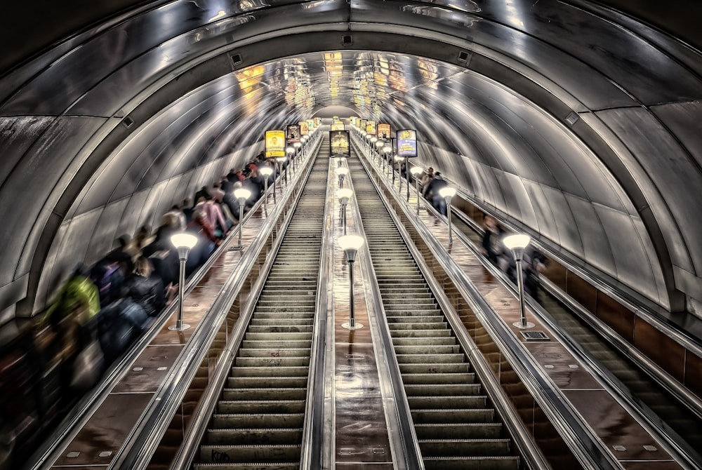 people walking on escalator inside building