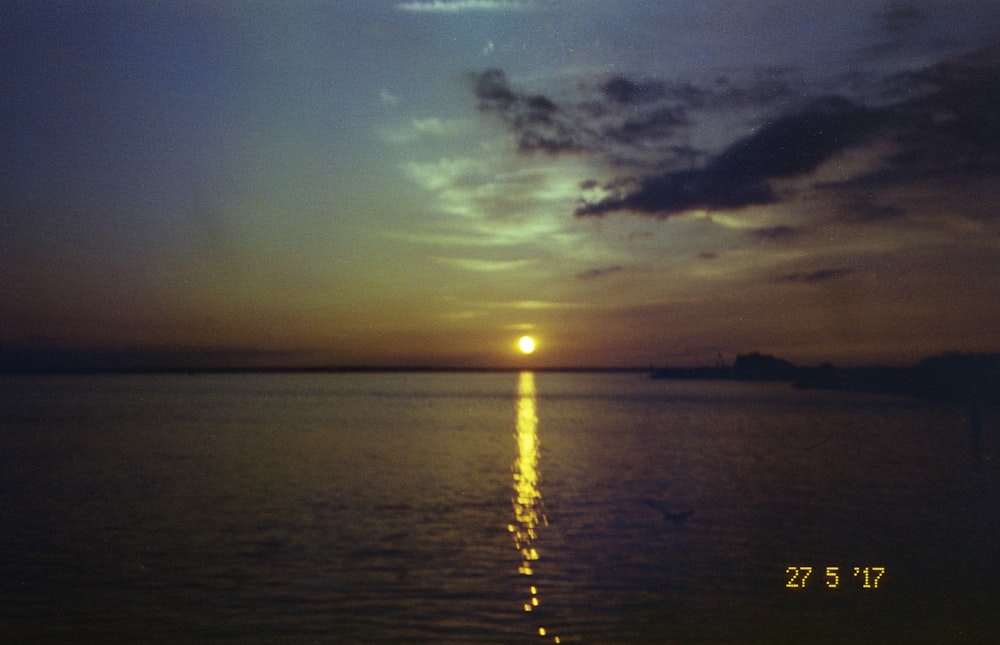 body of water during sunset