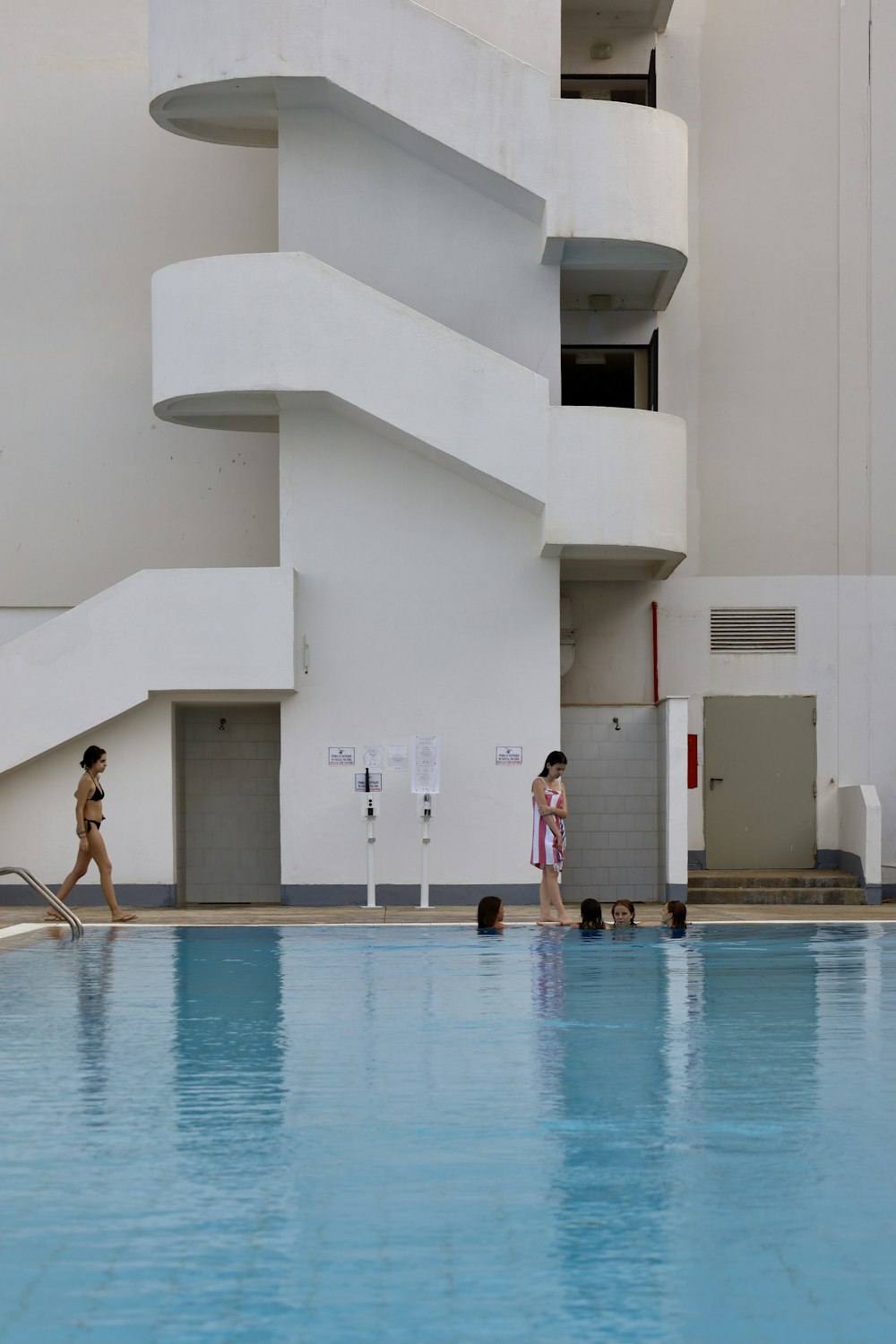 2 women in swimming pool during daytime