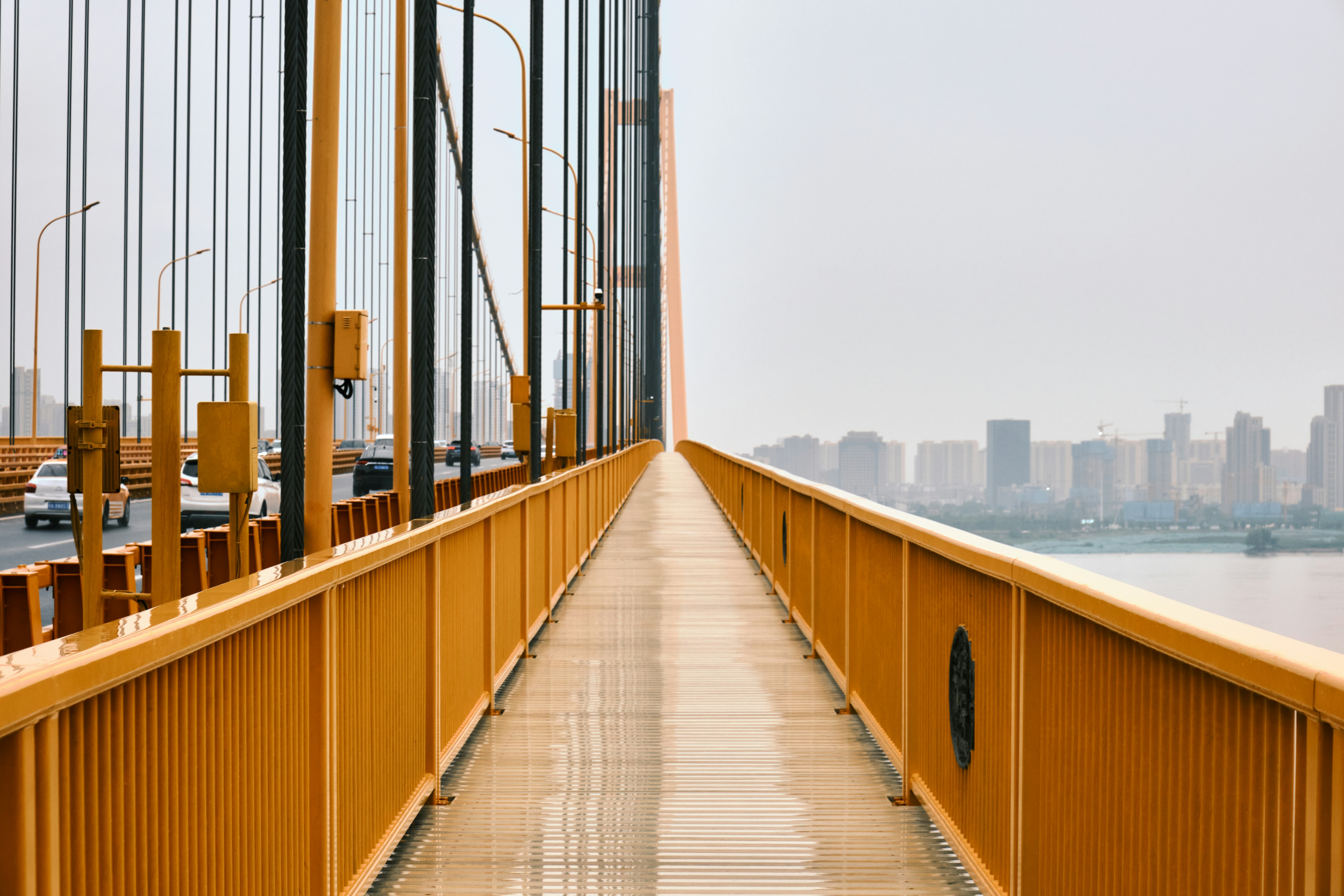 brown wooden bridge over body of water during daytime