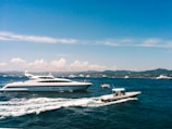 white and blue boat on sea under blue sky during daytime