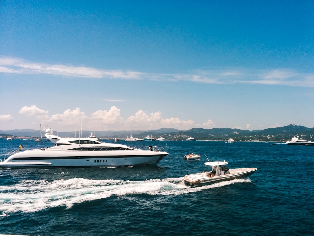 white and blue boat on sea under blue sky during daytime