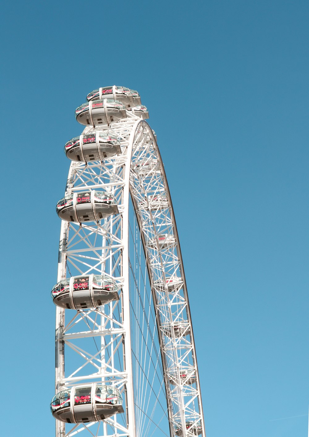 white and red ferris wheel under blue sky during daytime