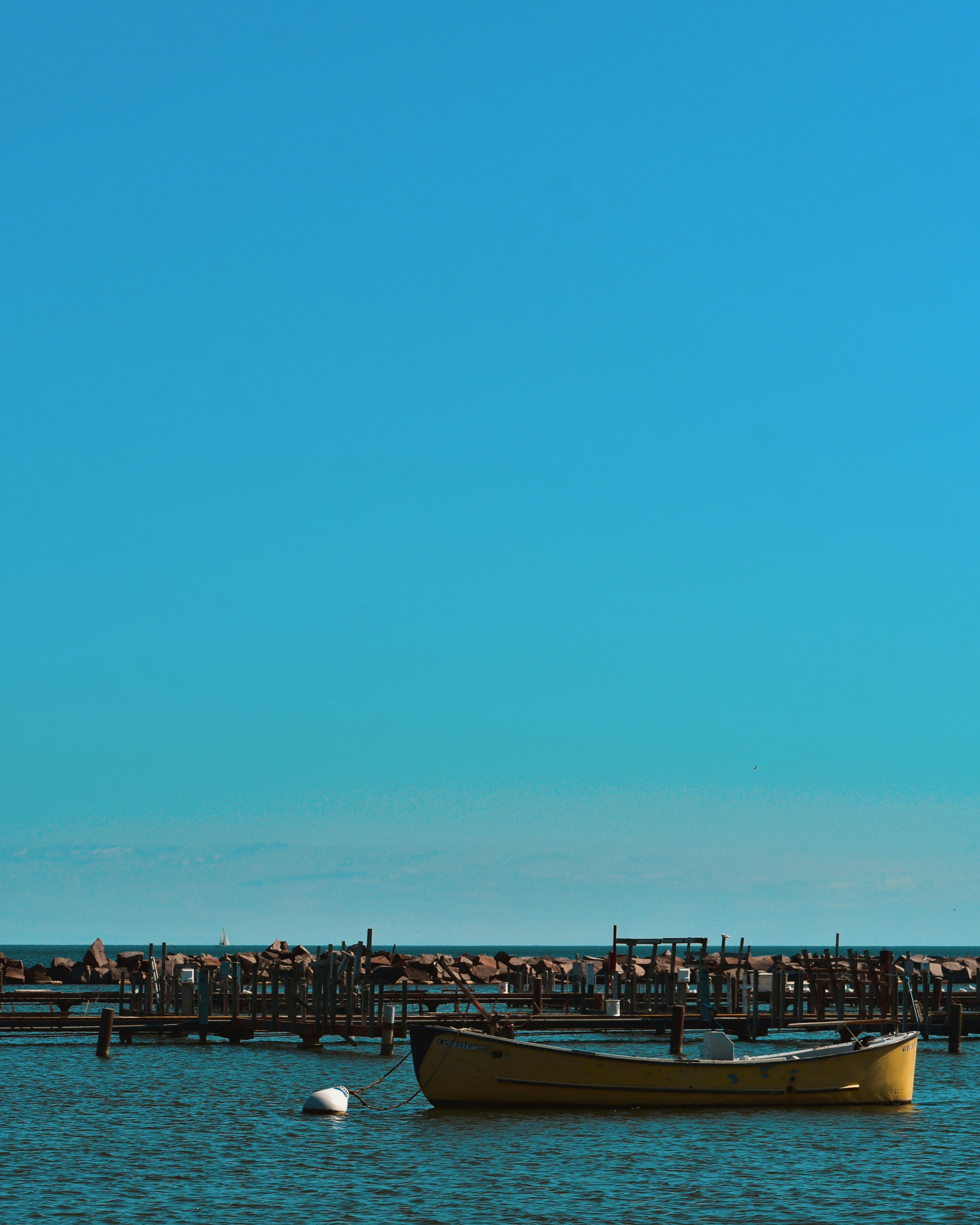 brown wooden boat on sea shore during daytime