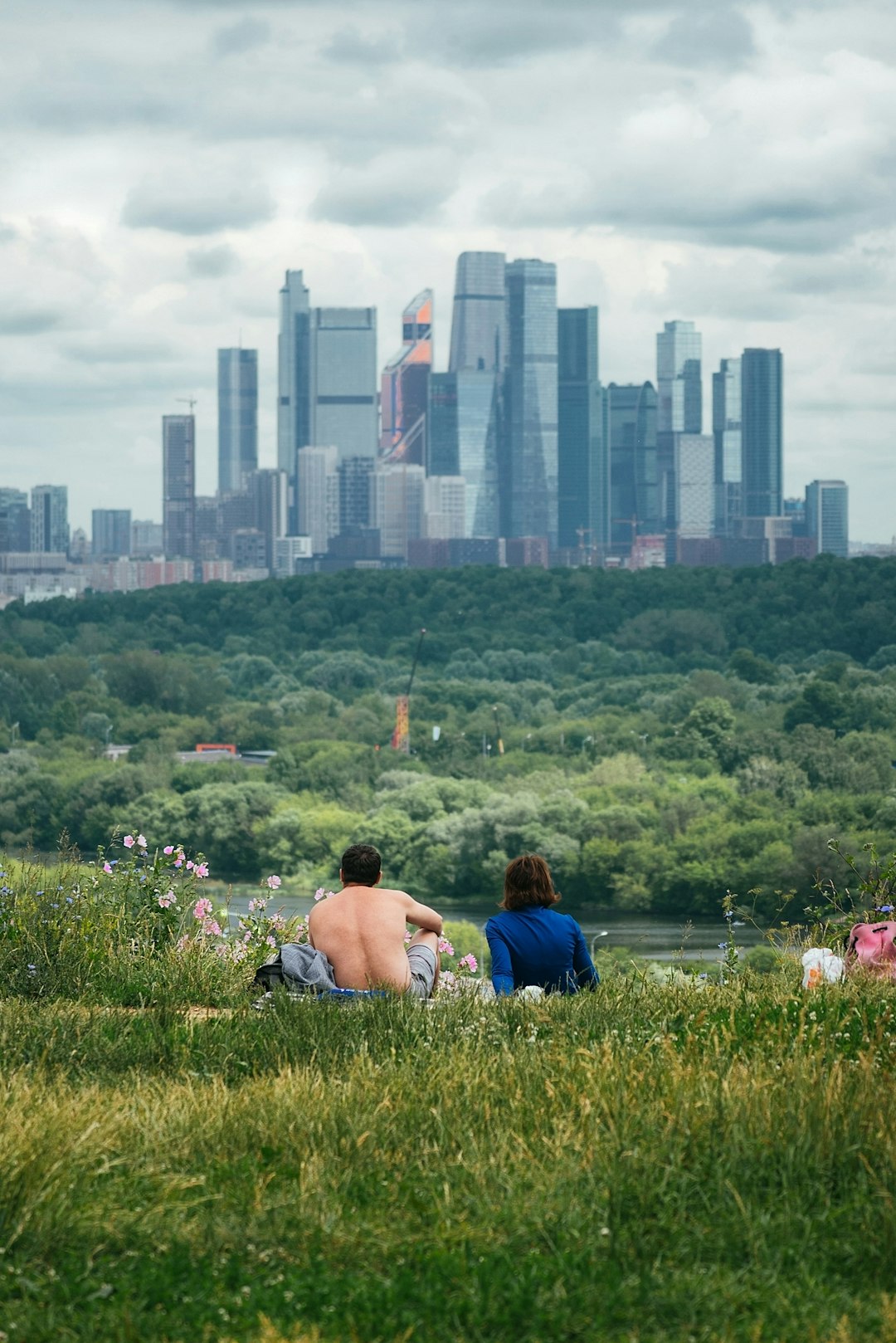 couple sitting on green grass field during daytime