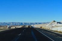 black asphalt road under blue sky during daytime