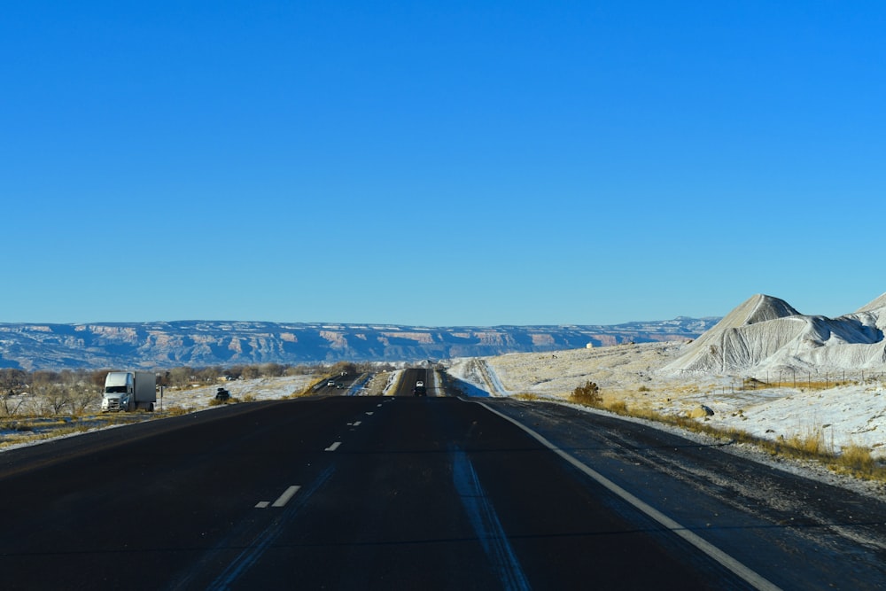 black asphalt road under blue sky during daytime