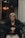 woman in black and gray sweater wearing eyeglasses