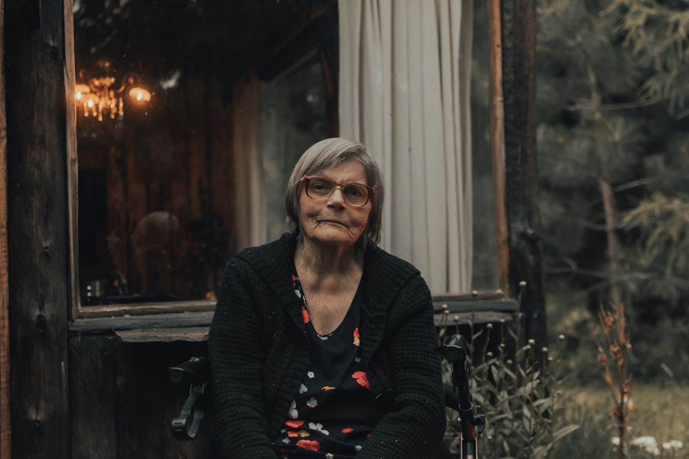 woman in black cardigan sitting on chair