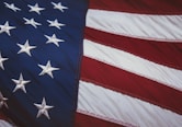 us a flag on white and red striped textile