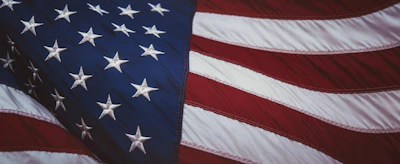 The American flag with white stars on blue and red and white stripes