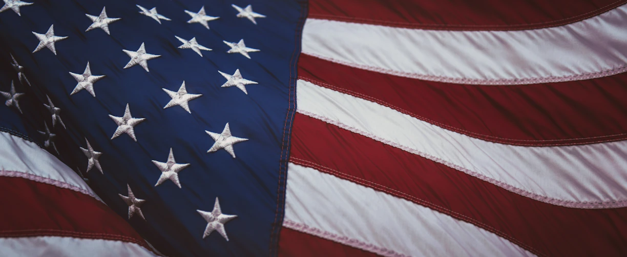 The American flag with white stars on blue and red and white stripes