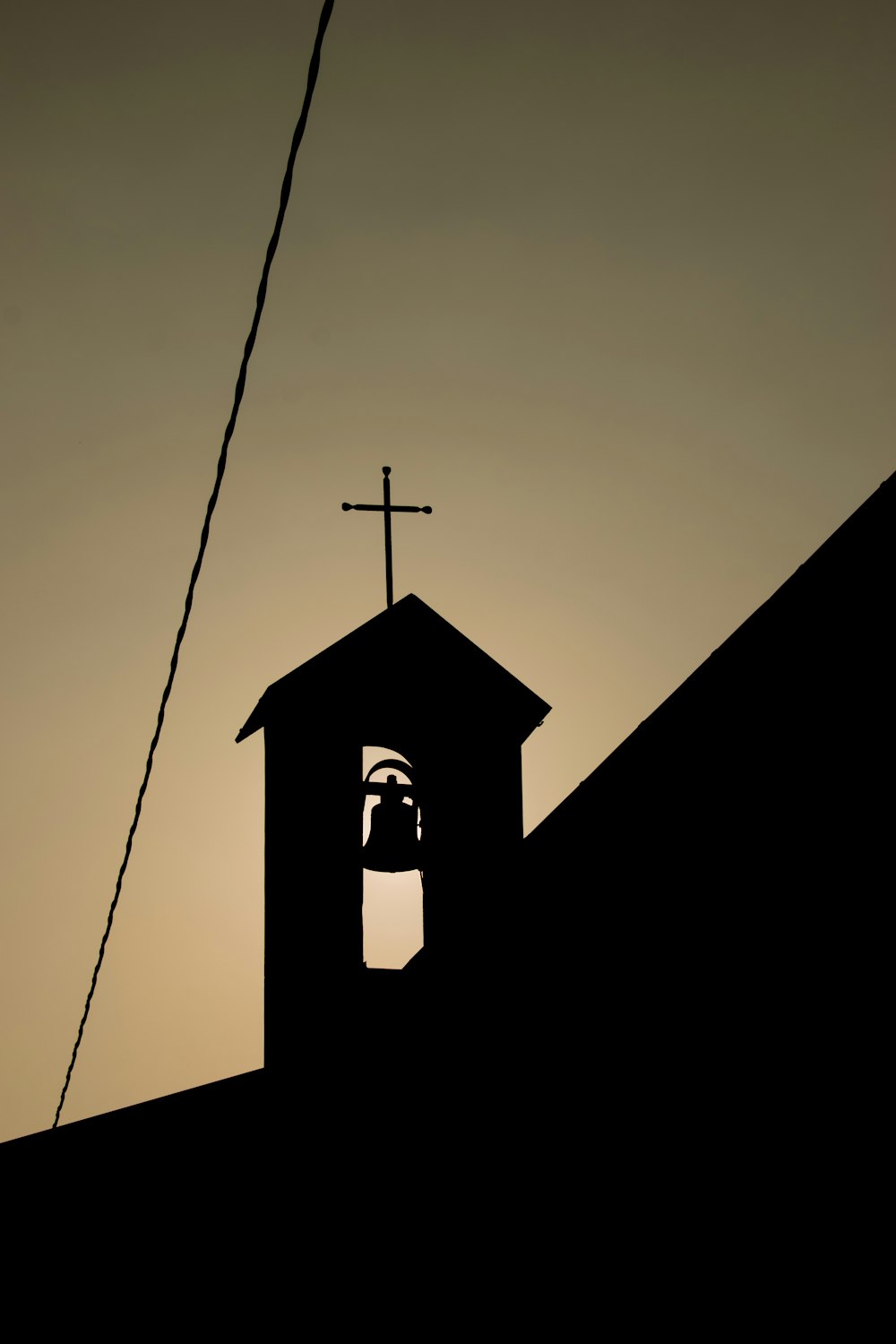 silhouette of cross on top of building