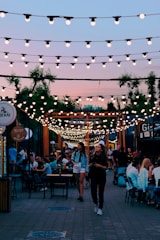 people sitting on chairs near brown wooden building during night time