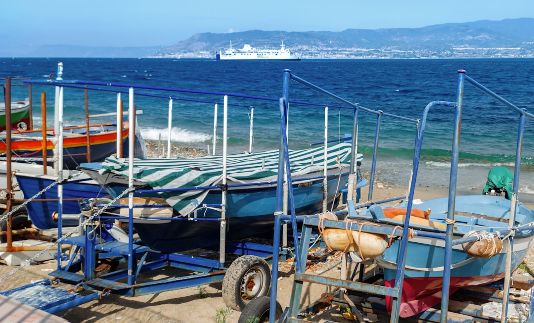 blue and red boat on beach during daytime