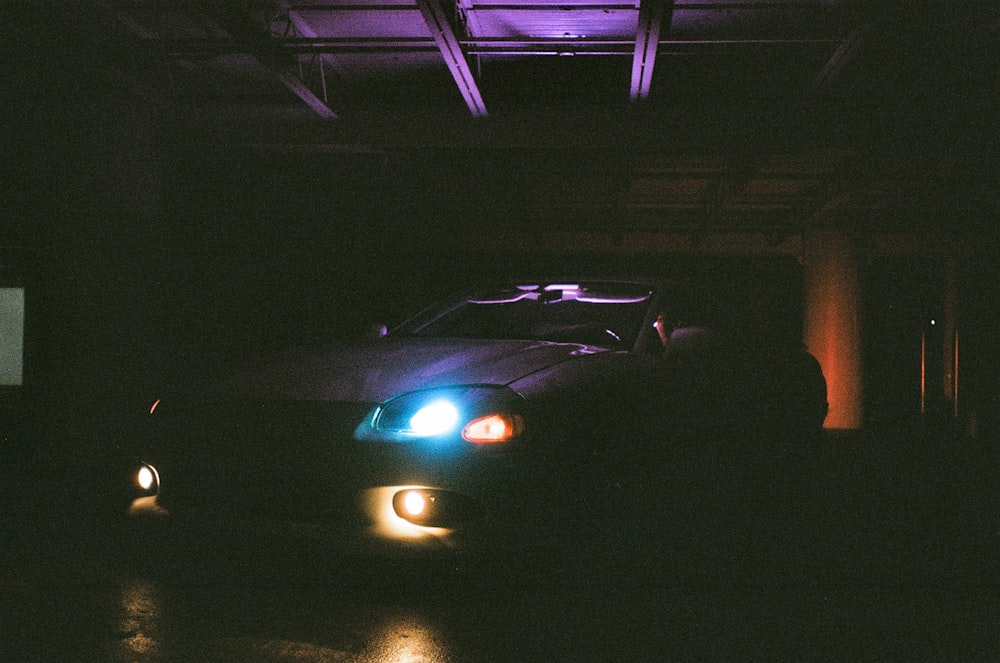 white car on road during night time