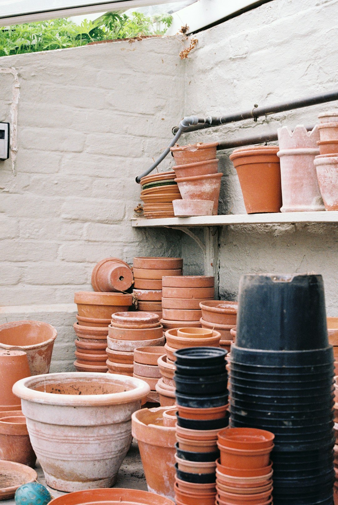 brown clay pots on brown wooden shelf
