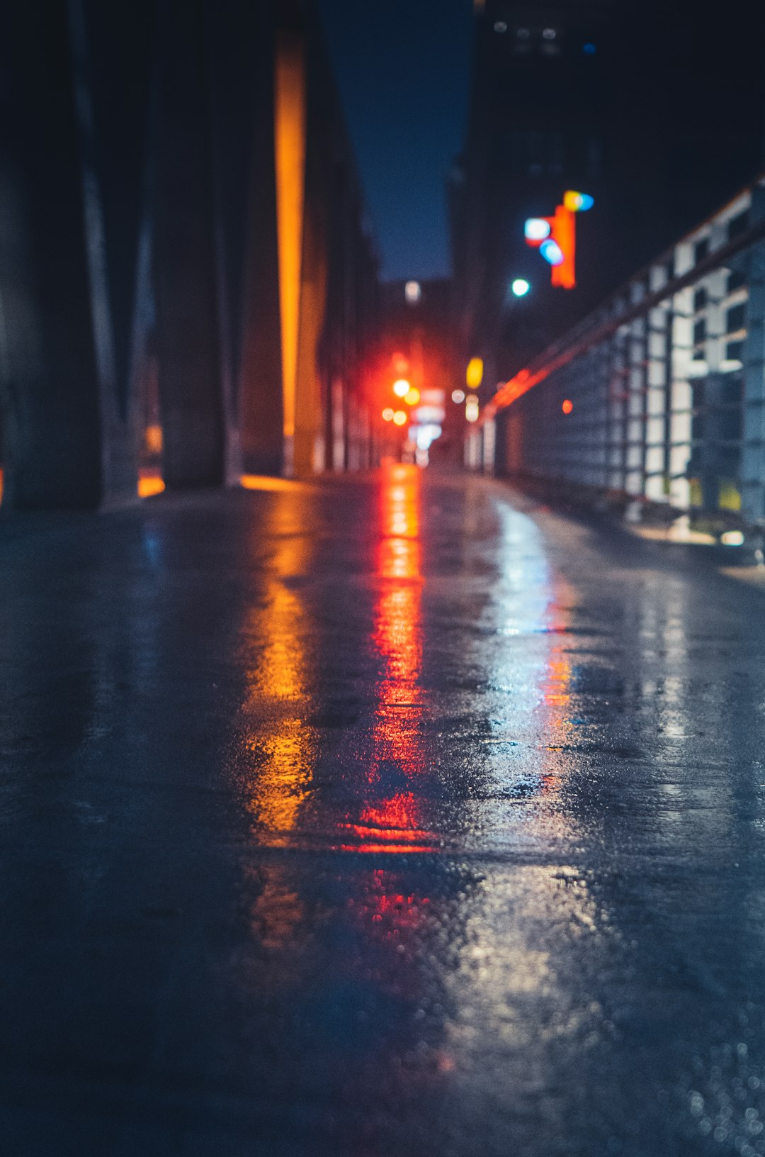 wet road with red lights during night time