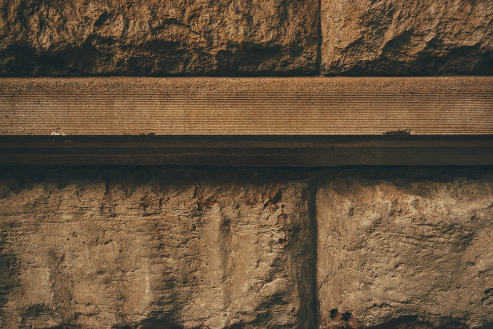 brown wooden fence on brown rock formation