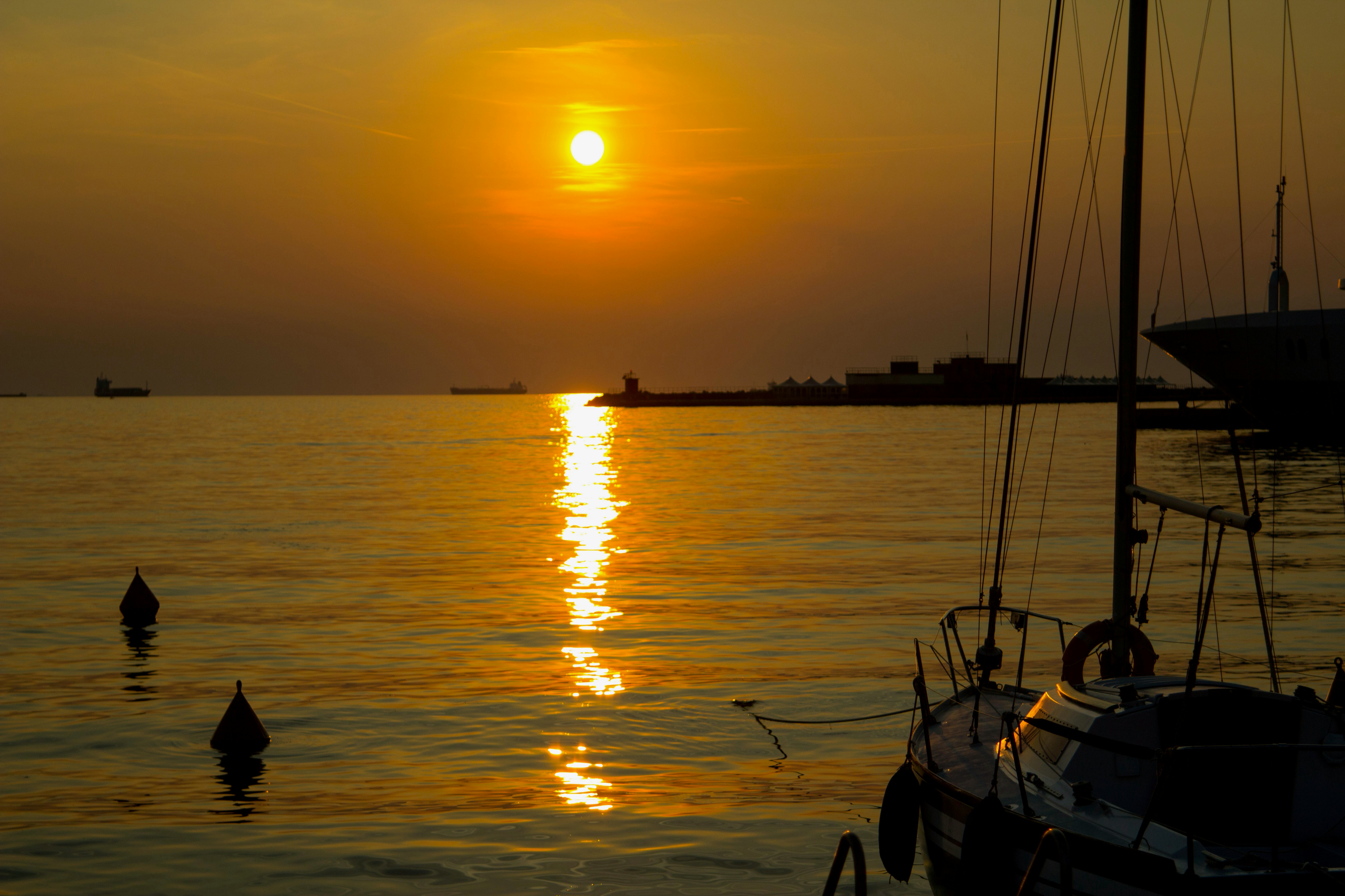 silhouette of people riding boat on sea during sunset, 