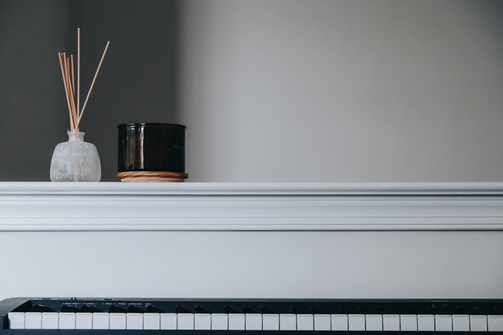 black and white ceramic mug on white wooden shelf