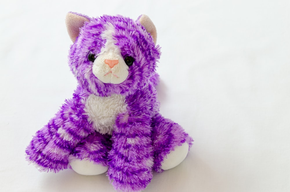 purple and white cat plush toy
