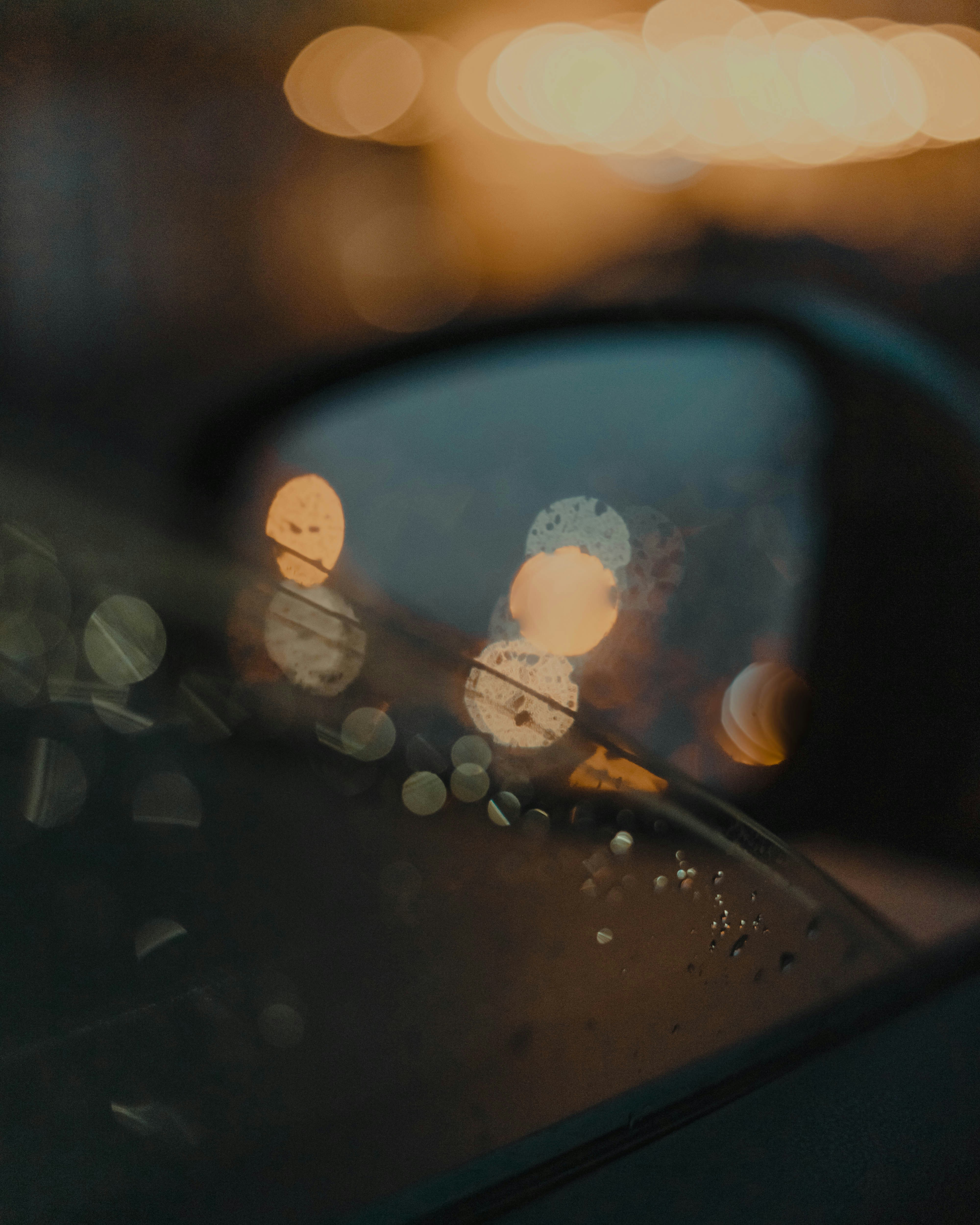 car side mirror with water droplets