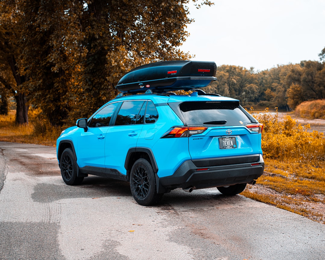 blue chevrolet 5 door hatchback on road during daytime