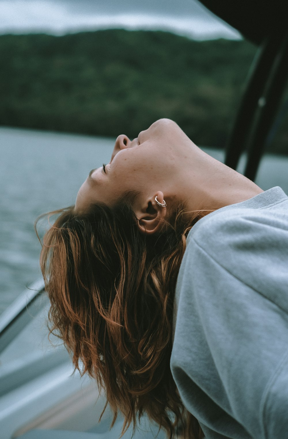 woman in gray shirt looking at the window