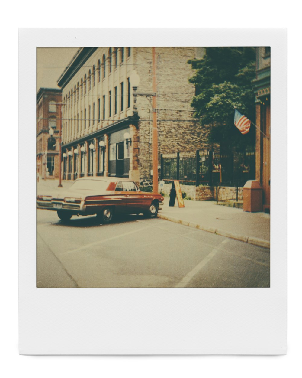 red car parked beside building