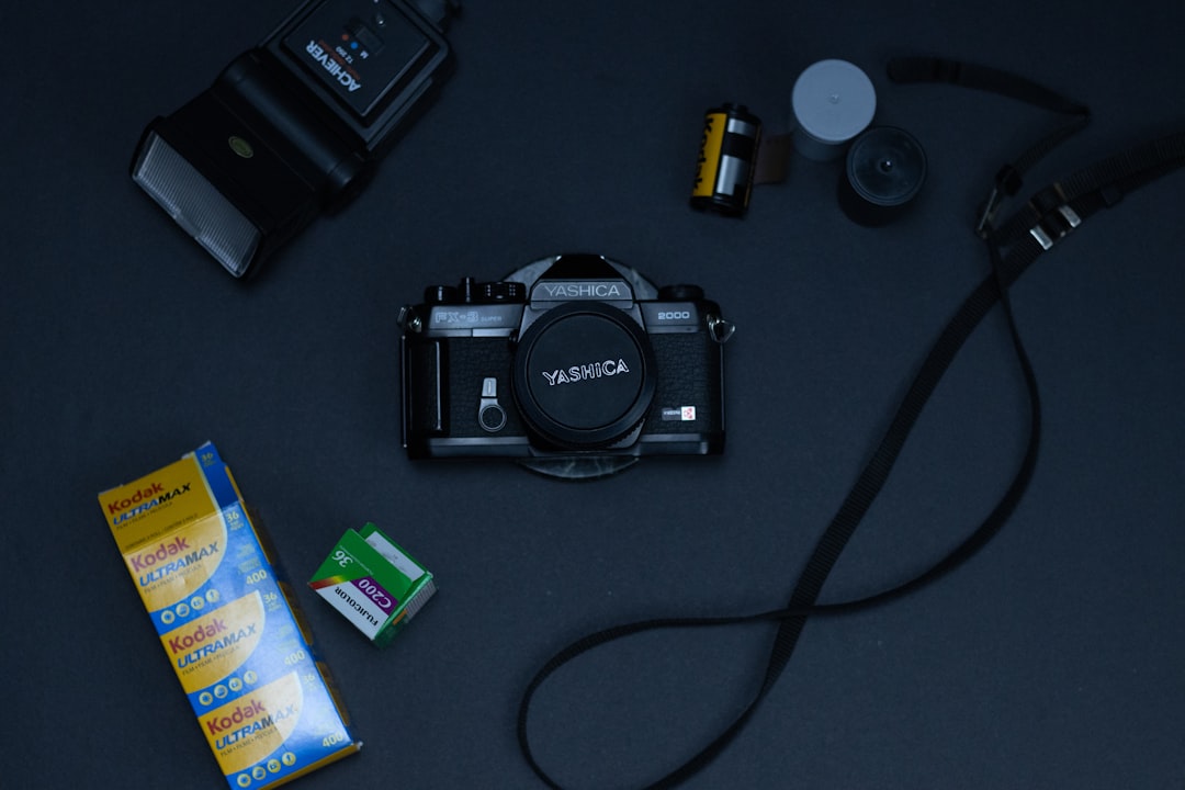 black nikon dslr camera on black table,
