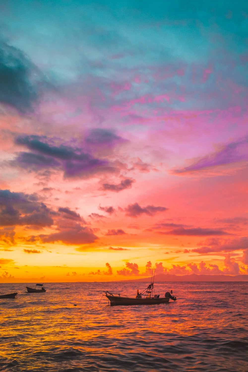 silhouette of boat on sea during sunset