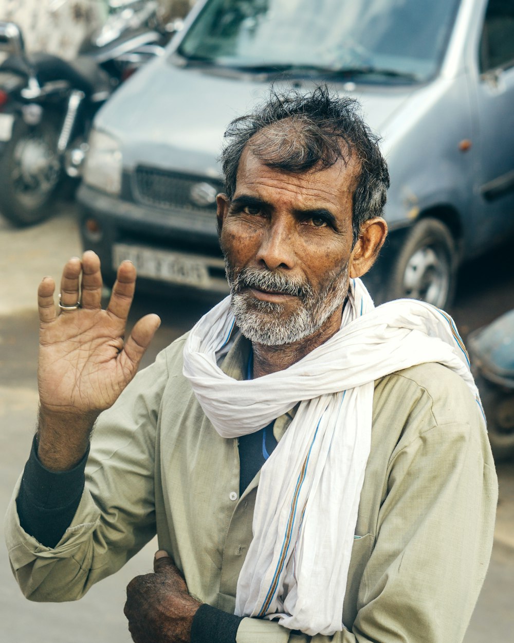 man in white dress shirt and white scarf