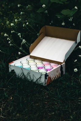 white and purple floral box on green grass