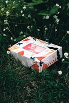 white and red floral box on green grass