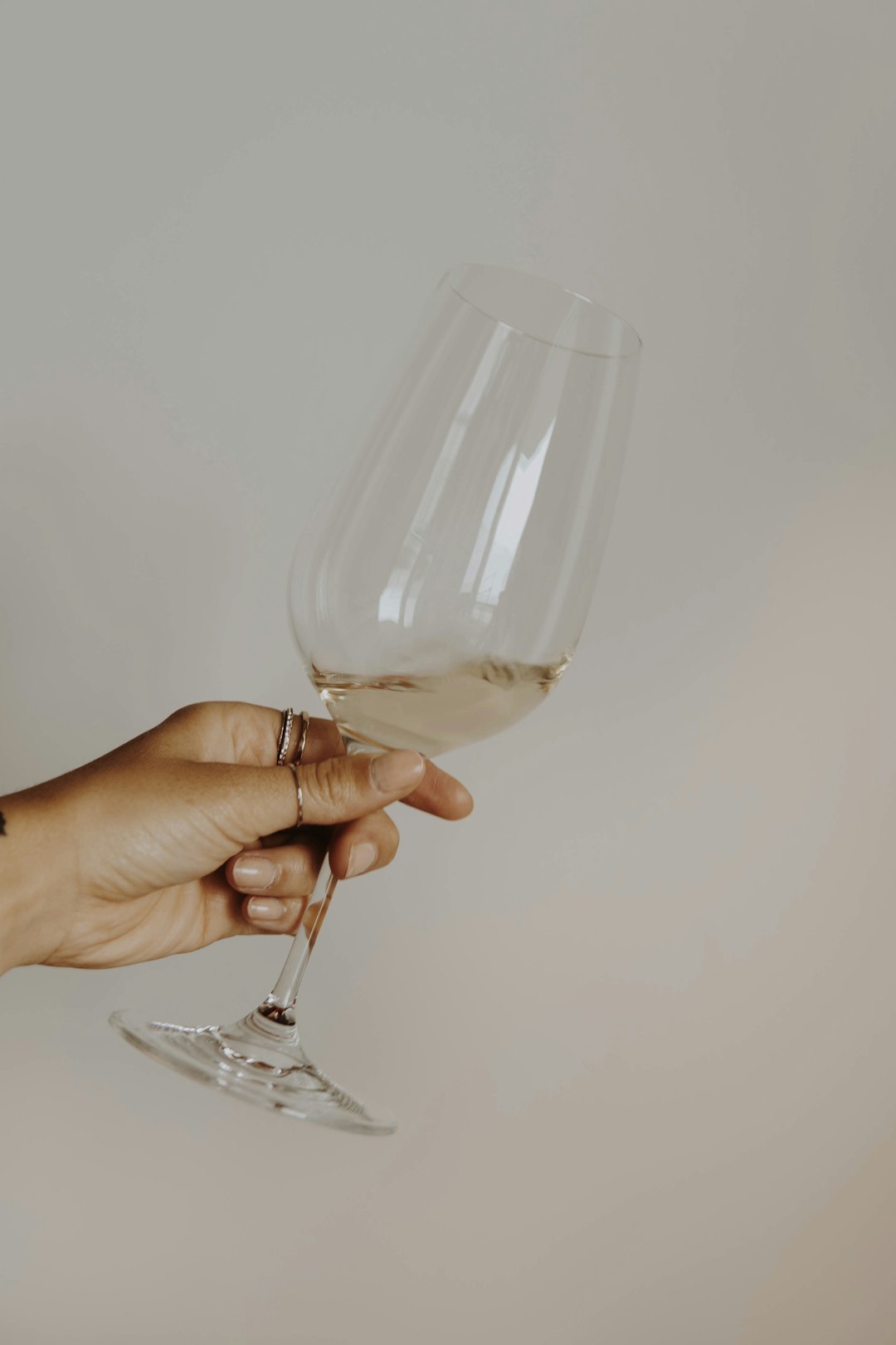 person holding clear wine glass