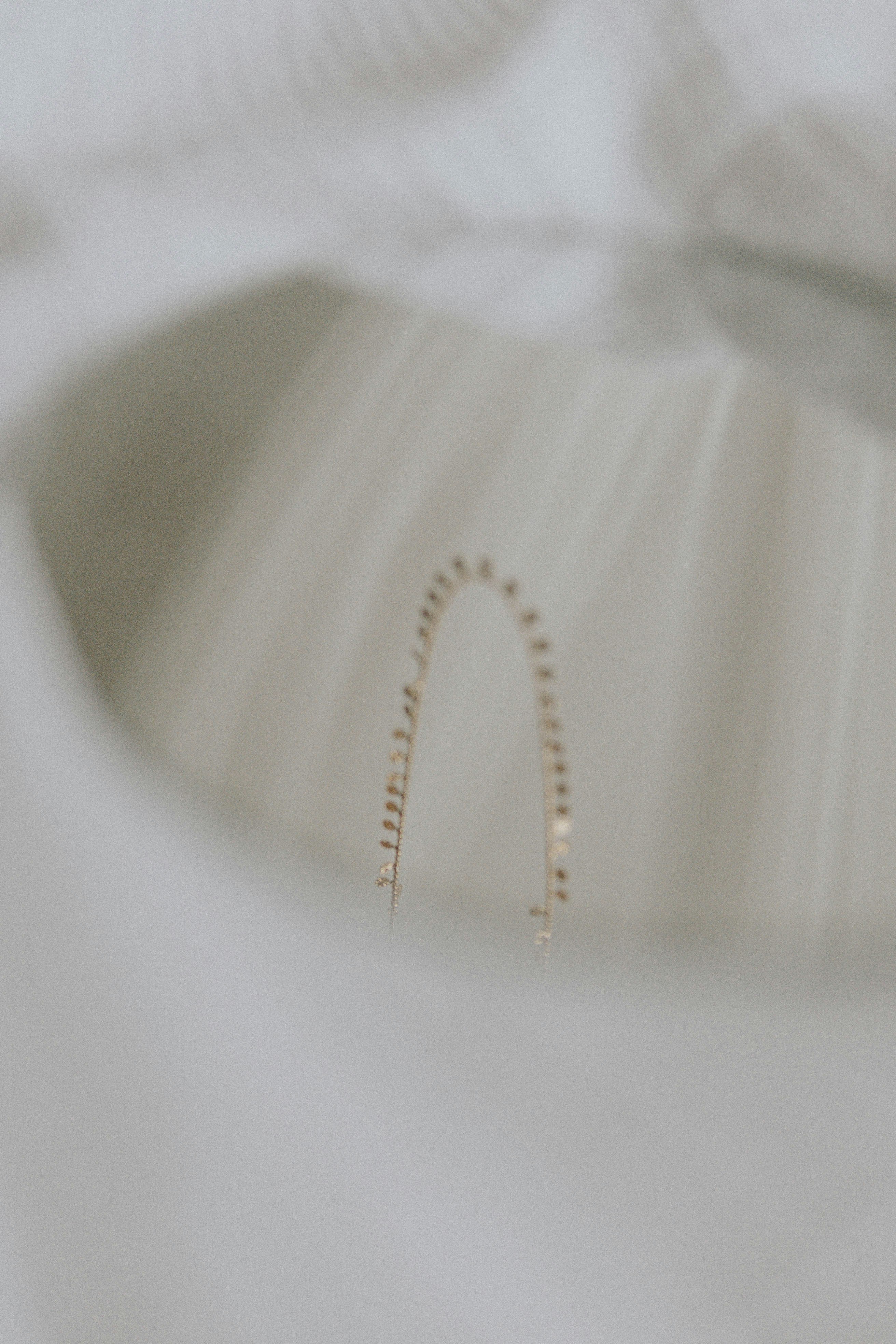 gold bracelet on white textile