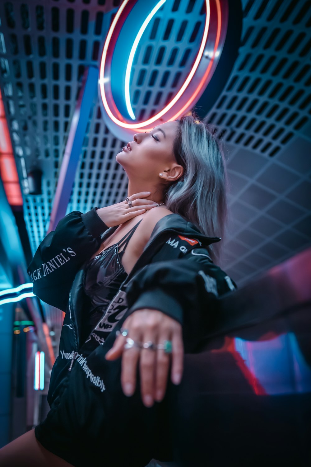 woman in black leather jacket holding her hair