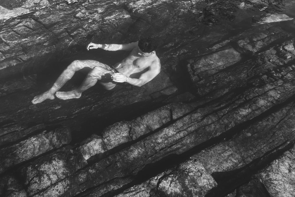 grayscale photo of man in water