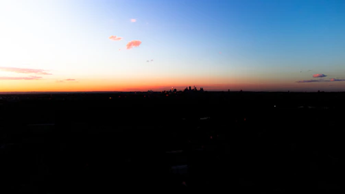 Minimalist line art of a city skyline at sunset.