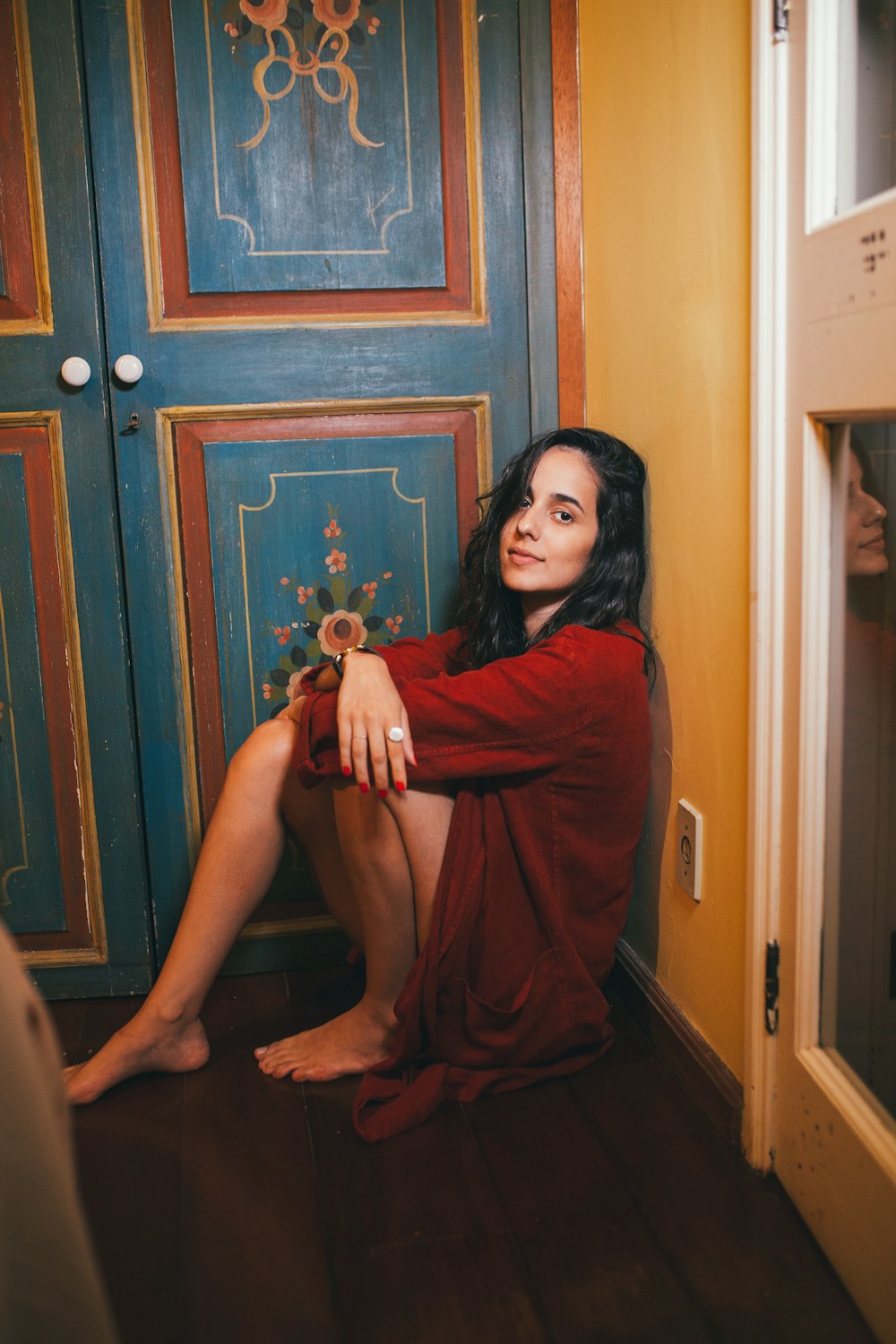 woman in red dress sitting on floor