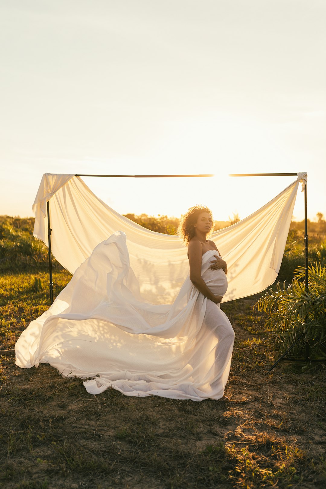 woman in white wedding dress holding white veil