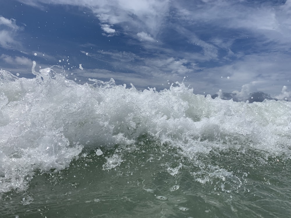 ocean waves under blue sky during daytime