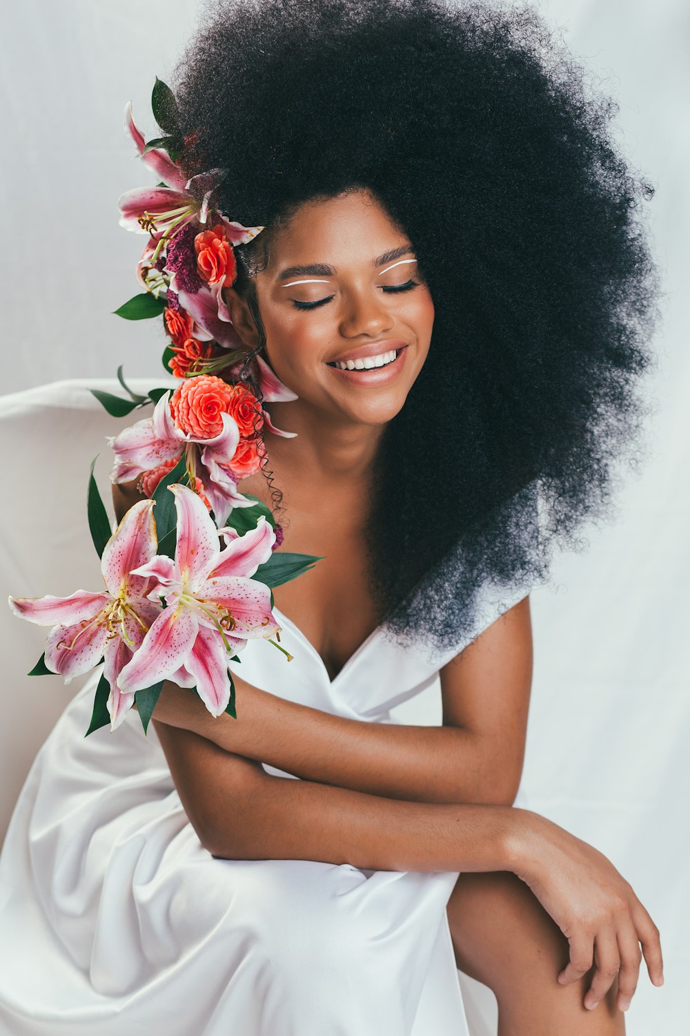 woman in white sleeveless dress with red and white flower crown