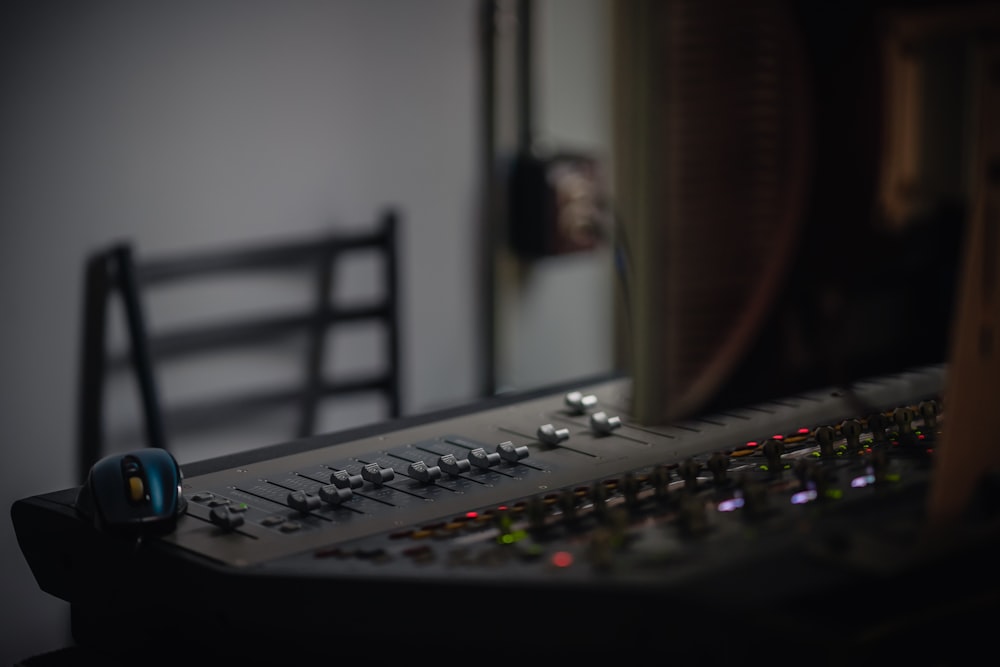 black audio mixer near brown wooden cabinet