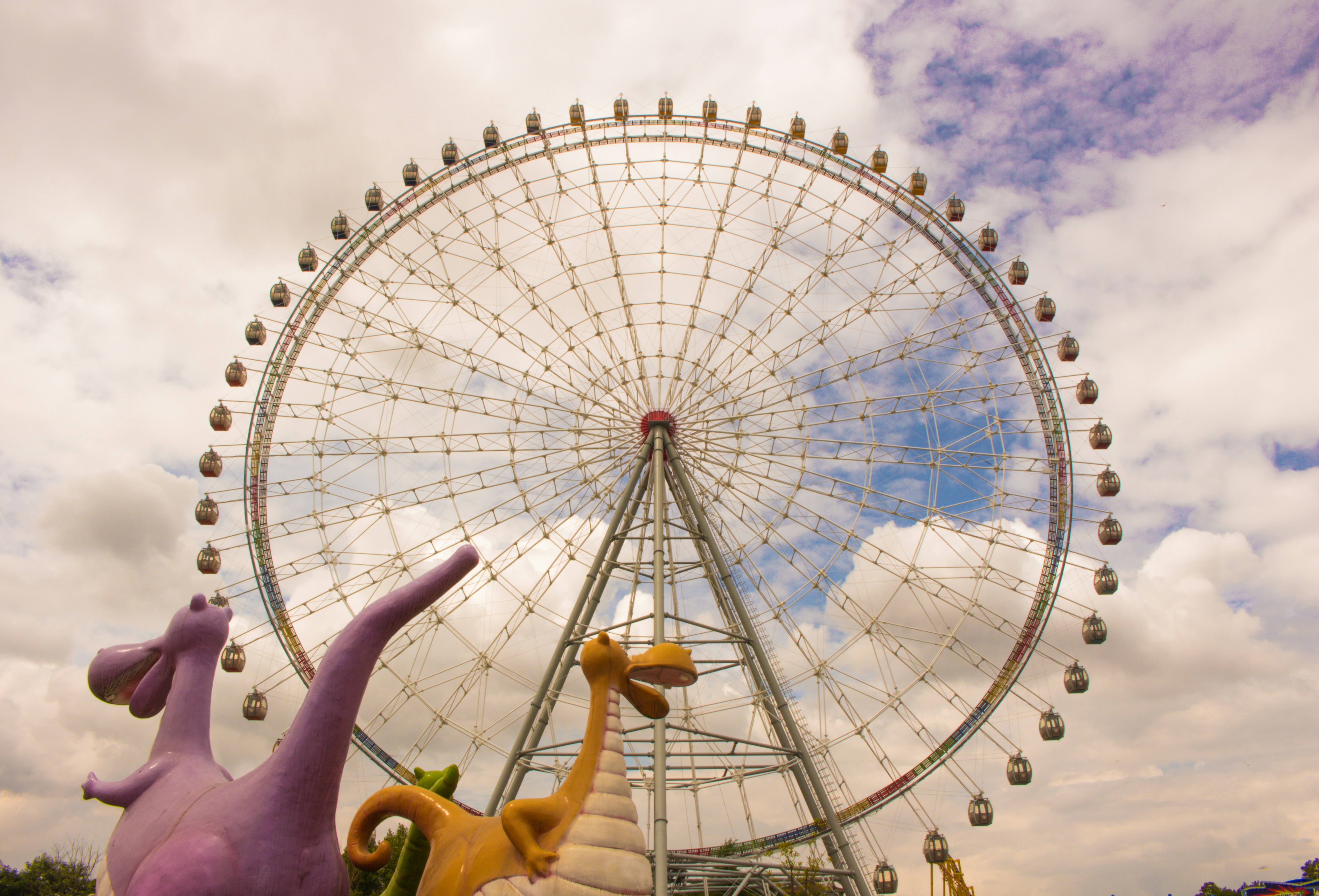 white ferris wheel under white clouds during daytime