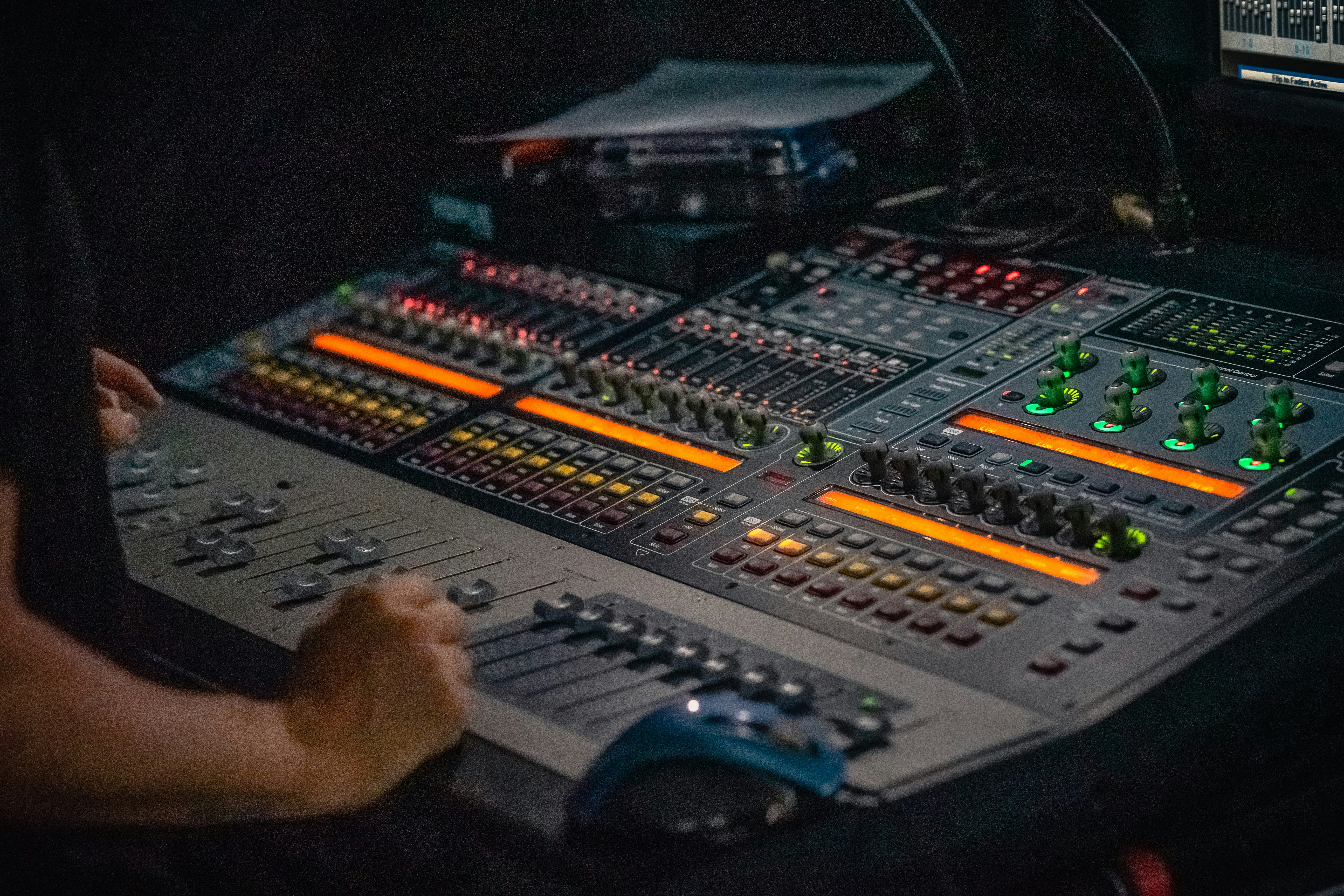 person holding gray and black audio mixer
